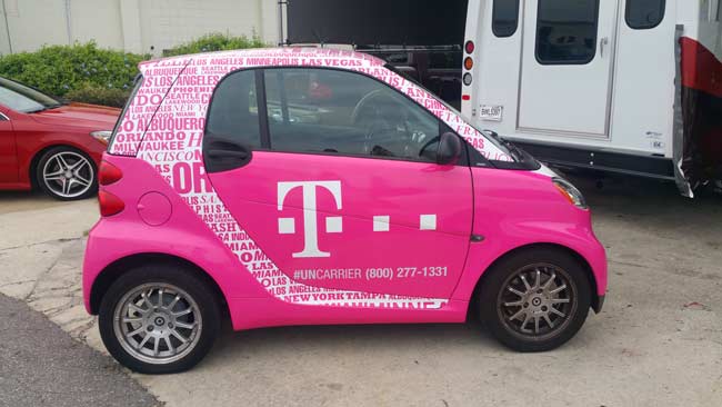 Mini car fully wrapped with t-mobile advertising