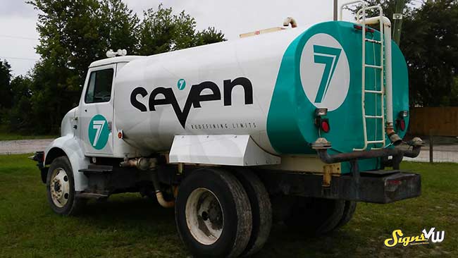 Truck with a teal and white vehicle wrap