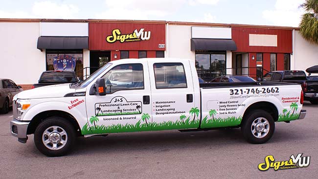 Picture of a truck in front of the Signs VW store wrapped with the J&S Professional Lawn Care & Landscaping Services company advertising